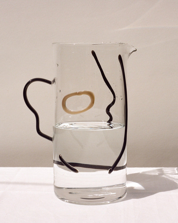 La Danse clear pitcher with face silhouette